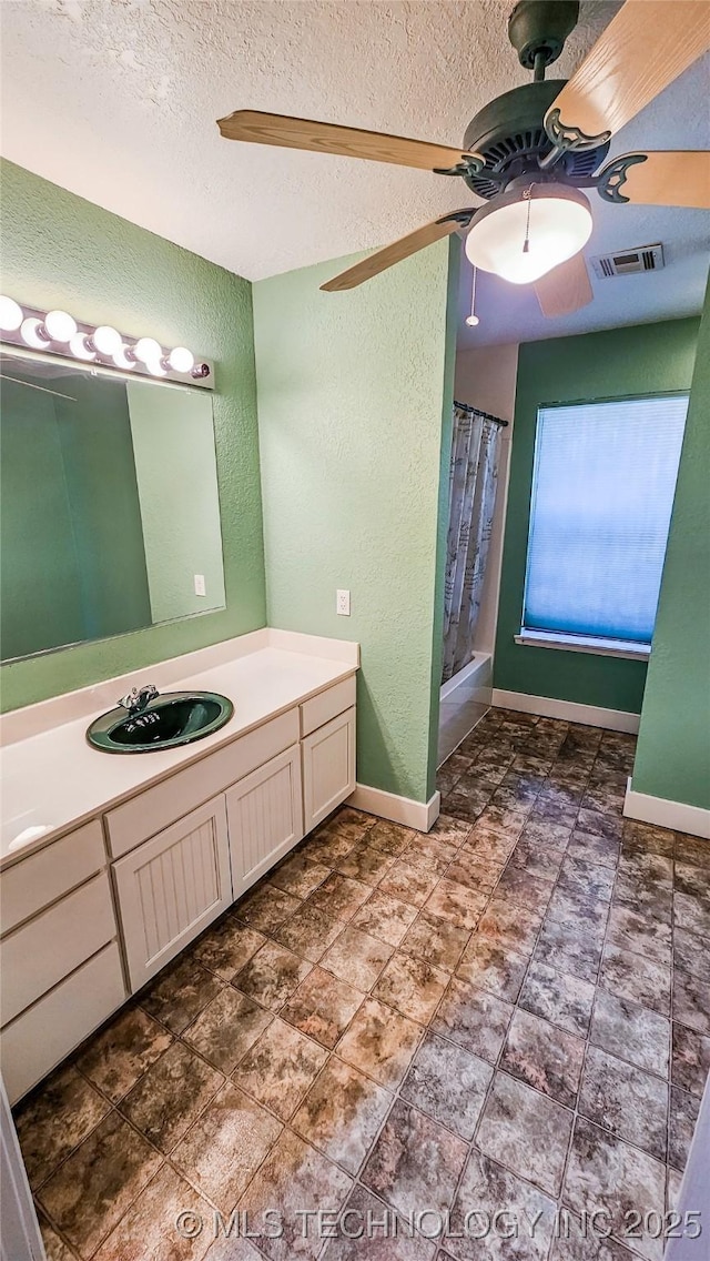116568 S 4268th Rd, Checotah, OK 74426 - full bath featuring ceiling fan, a textured wall, vanity, a shower with curtain, and baseboards