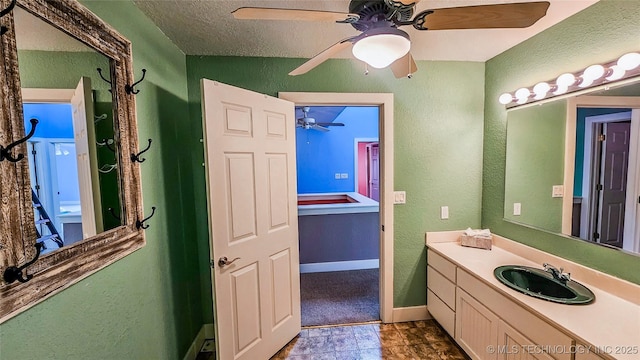 116568 S 4268th Rd, Checotah, OK 74426 - bathroom with vanity, a textured wall, a ceiling fan, baseboards, and a textured ceiling