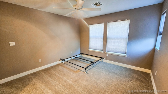 unfurnished bedroom featuring ceiling fan and carpet flooring