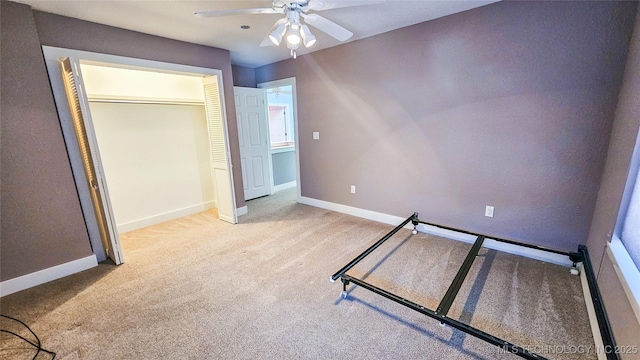 unfurnished bedroom featuring light colored carpet and ceiling fan