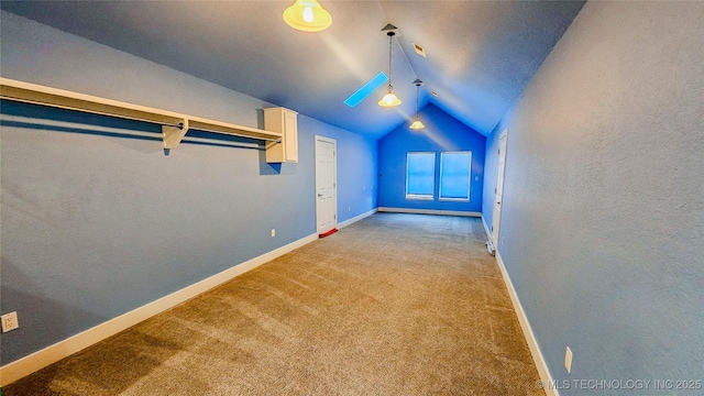 bonus room with vaulted ceiling and light colored carpet