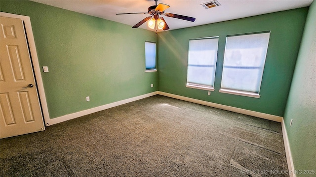 carpeted spare room with ceiling fan