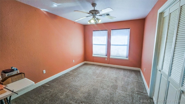 unfurnished bedroom with ceiling fan, carpet floors, and a closet