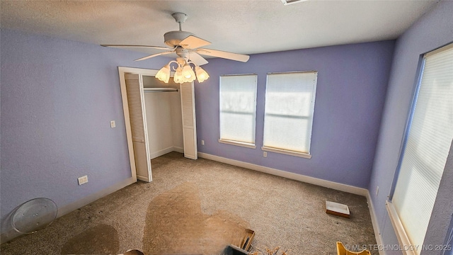 116568 S 4268th Rd, Checotah, OK 74426 - unfurnished bedroom featuring carpet, multiple windows, a closet, and ceiling fan