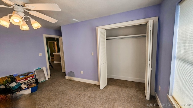 unfurnished bedroom featuring a closet, ceiling fan, and carpet flooring