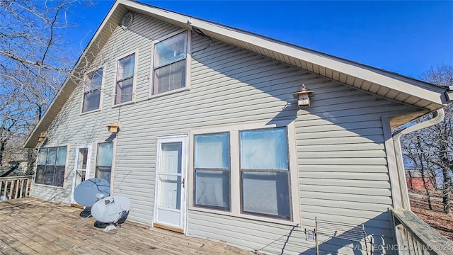 back of property featuring a wooden deck