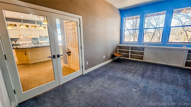 entryway with french doors and dark colored carpet