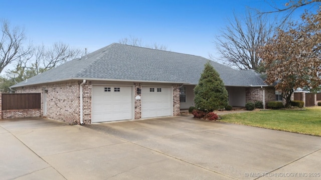 single story home featuring a garage and a front lawn