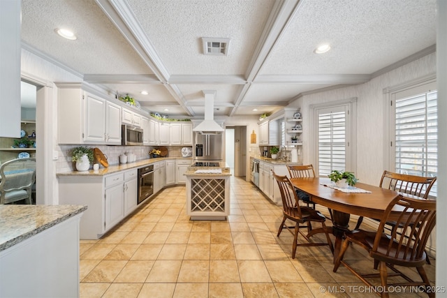 kitchen featuring stainless steel appliances, coffered ceiling, light stone countertops, white cabinets, and a kitchen island