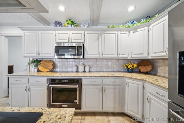 kitchen featuring backsplash, beam ceiling, black appliances, white cabinets, and a textured ceiling