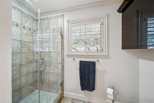 bathroom featuring a shower with door and crown molding