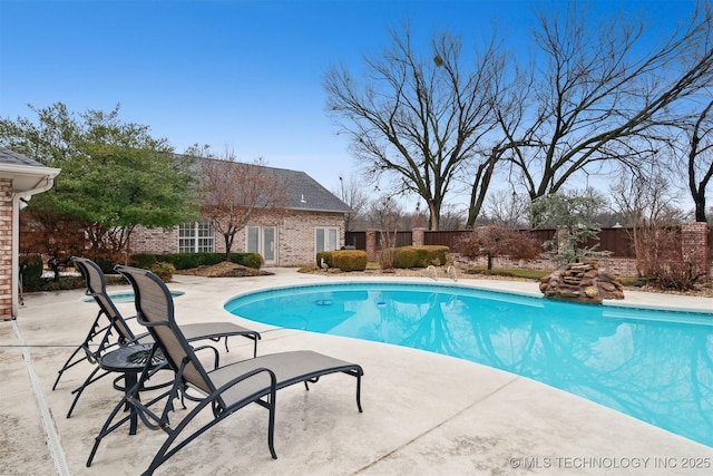 view of swimming pool with a patio area