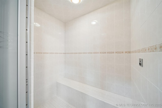 bathroom with tiled shower