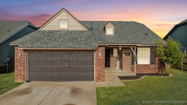 view of front of home with a garage and a yard