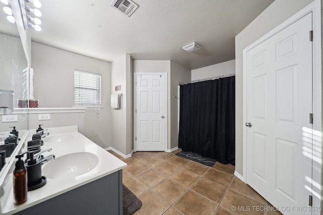 bathroom featuring vanity, curtained shower, and tile patterned flooring