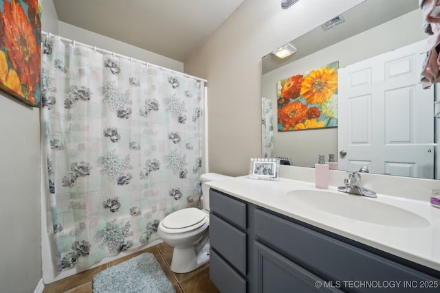 bathroom with vanity, toilet, curtained shower, and tile patterned flooring