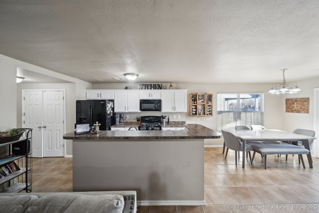 kitchen with hanging light fixtures, light tile patterned floors, white cabinets, and black appliances