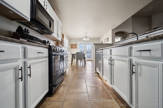 kitchen with a chandelier, white cabinets, pendant lighting, tile patterned flooring, and black appliances