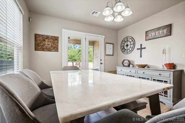 dining room featuring a healthy amount of sunlight and a notable chandelier