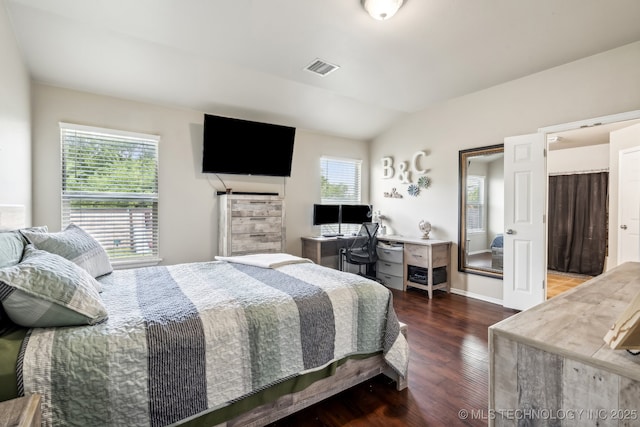 bedroom with lofted ceiling and dark hardwood / wood-style floors