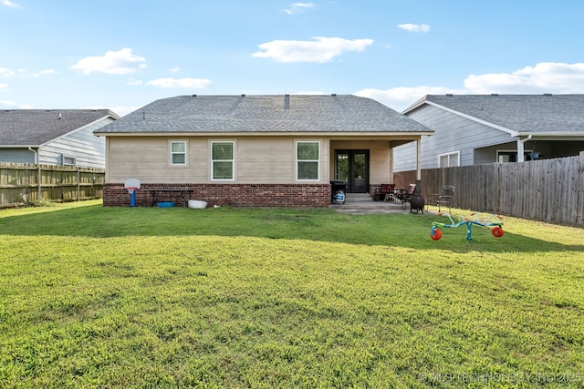 rear view of house featuring a patio and a lawn