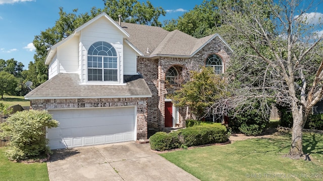 view of front of home featuring a garage and a front yard