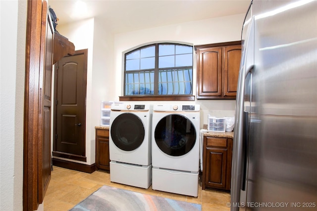 washroom with cabinets and separate washer and dryer