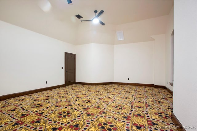 unfurnished room with a high ceiling and ceiling fan