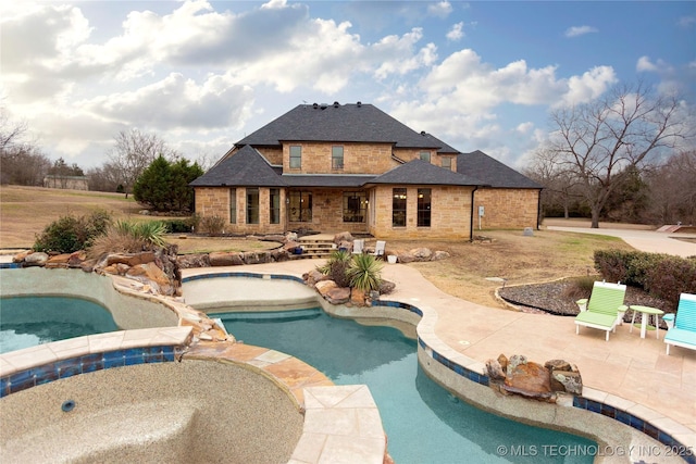 view of pool with a hot tub and a patio area