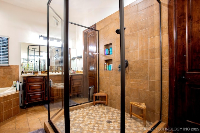 bathroom with vanity and shower with separate bathtub