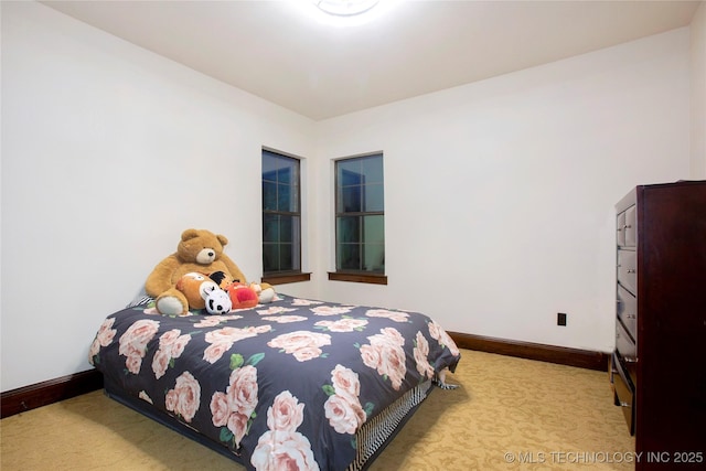 bedroom featuring light colored carpet