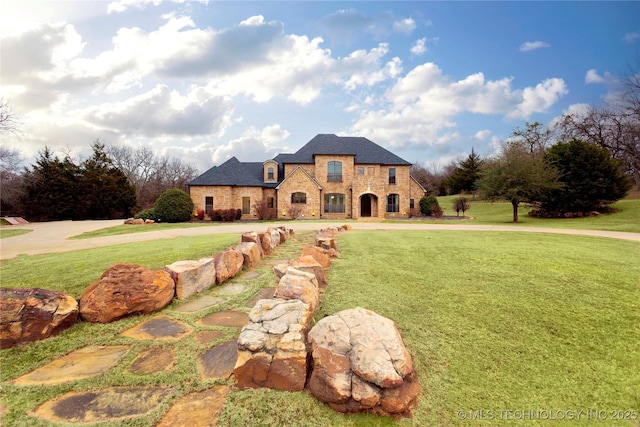 french country style house with a front yard