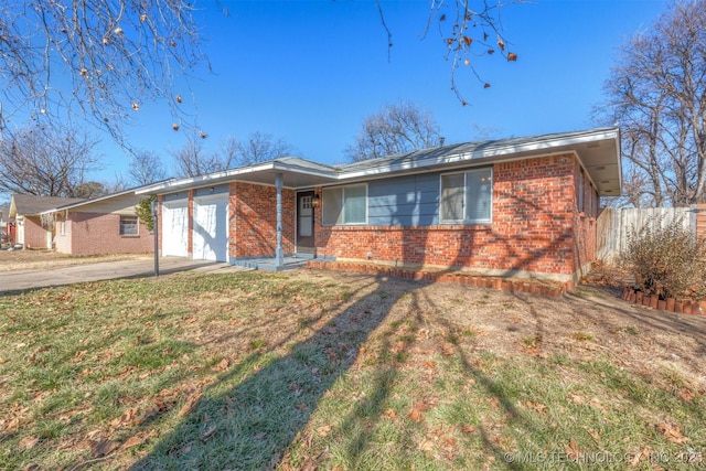 single story home with a garage and a front lawn