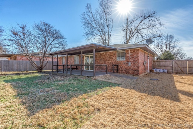 back of property featuring a patio and a lawn