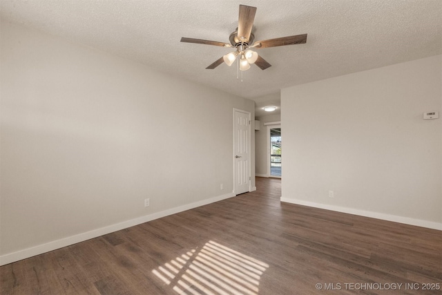 spare room with ceiling fan, dark wood-type flooring, and a textured ceiling