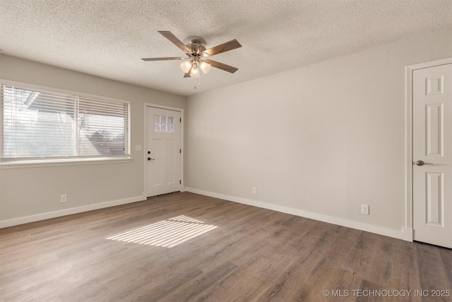 empty room with hardwood / wood-style floors, a textured ceiling, and ceiling fan