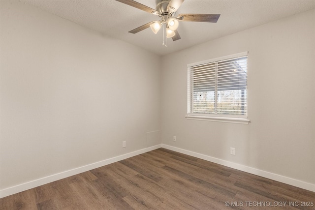 empty room with dark hardwood / wood-style floors, a textured ceiling, and ceiling fan