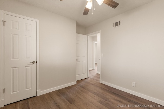 unfurnished bedroom featuring ceiling fan and hardwood / wood-style floors