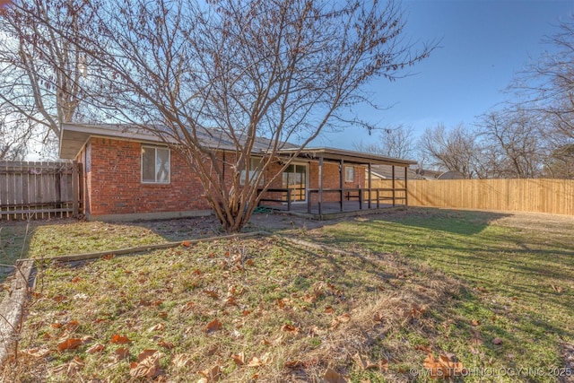 rear view of property with a yard