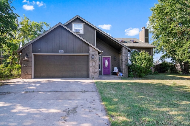 view of front of home with a garage and a front lawn