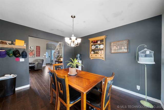 dining space featuring an inviting chandelier and dark hardwood / wood-style floors