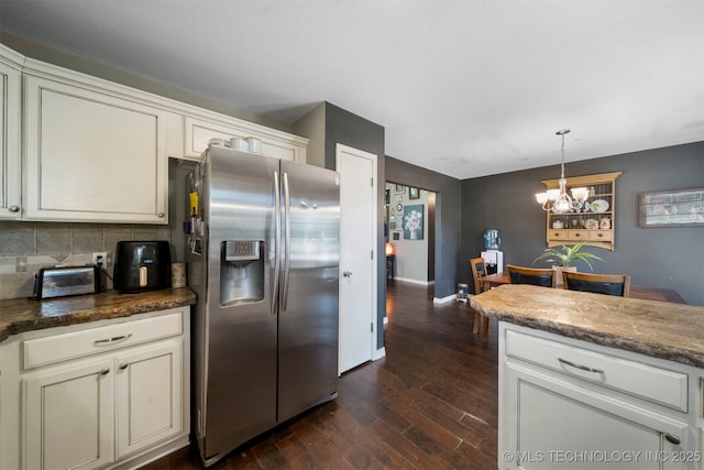 kitchen with decorative light fixtures, backsplash, a chandelier, stainless steel refrigerator with ice dispenser, and dark wood-type flooring