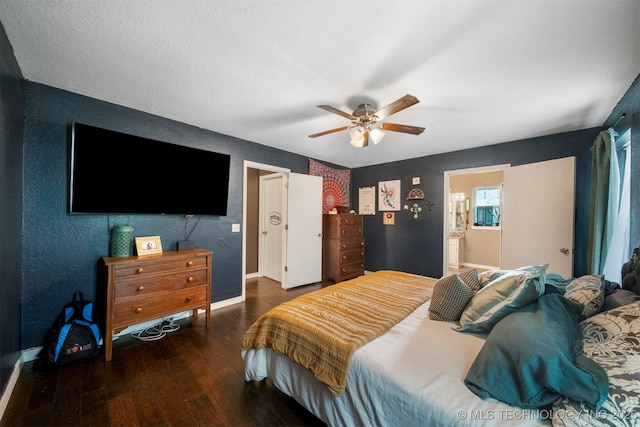 bedroom with dark wood-type flooring, ceiling fan, and ensuite bathroom