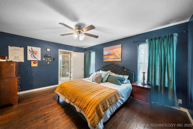 bedroom with ceiling fan, dark hardwood / wood-style floors, and a textured ceiling