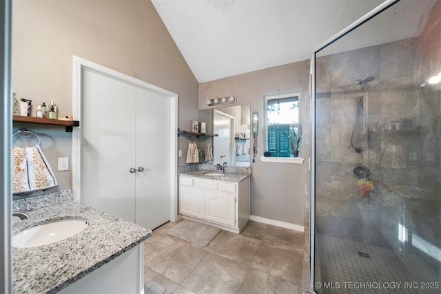 bathroom with lofted ceiling, vanity, tile patterned floors, and an enclosed shower