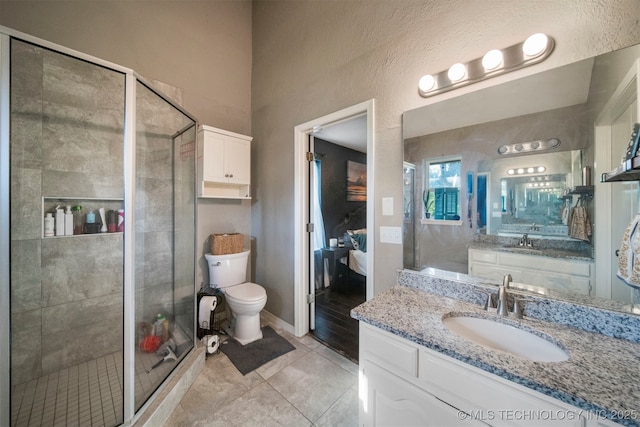 bathroom featuring vanity, tile patterned floors, and walk in shower