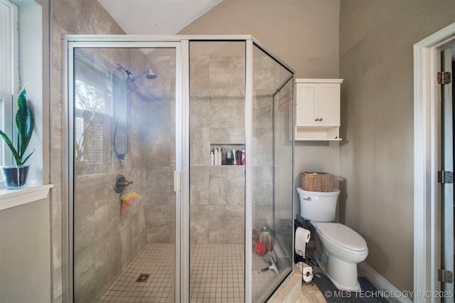 bathroom with an enclosed shower and toilet