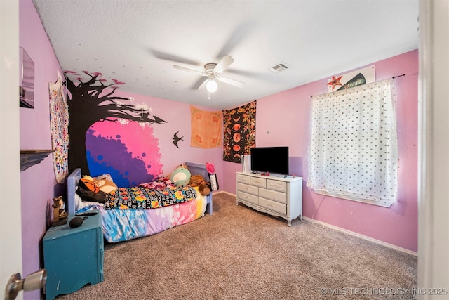 carpeted bedroom with a textured ceiling and ceiling fan