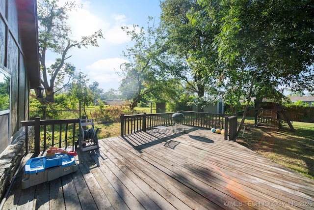 wooden terrace with a playground