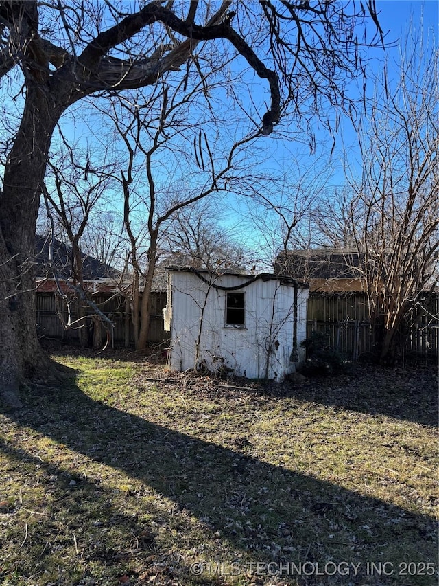 view of side of property with a yard and a storage shed